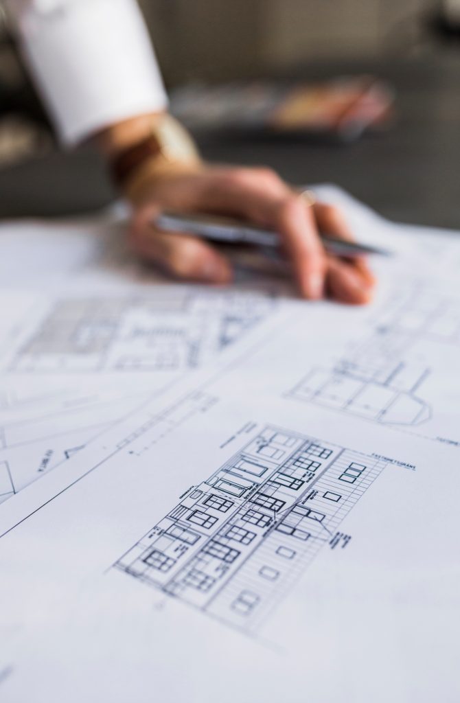 Architect reviewing blueprints at a workspace